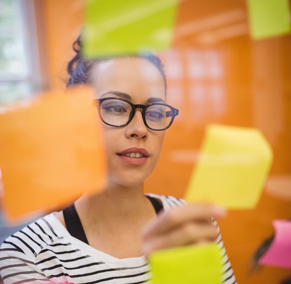 female-executive-reading-sticky-notes copy-2